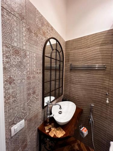 a bathroom with a sink and a mirror at Villa Valminuta in Ercolano