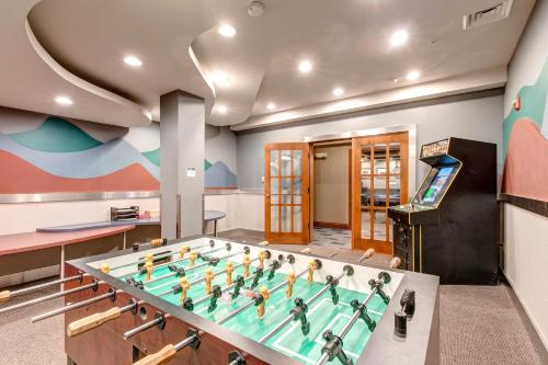 a gym with a pool table with a soccer game at Eagle Springs East 101: Red-wing Suite in Solitude