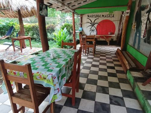 a dining room with a table and a piano at Hostal Así es mi Tierra in Balgue