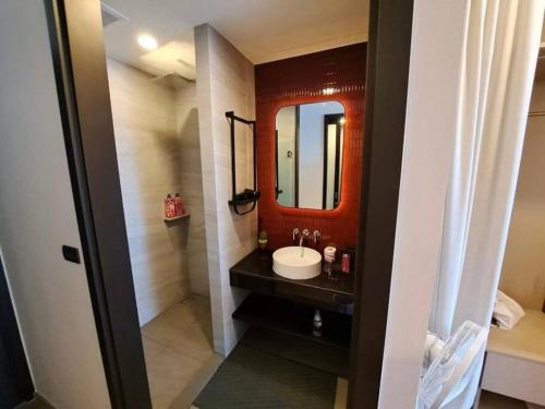 a bathroom with a sink and a mirror at Downtown Chic Condo High Floor #E59 in Pattaya Central