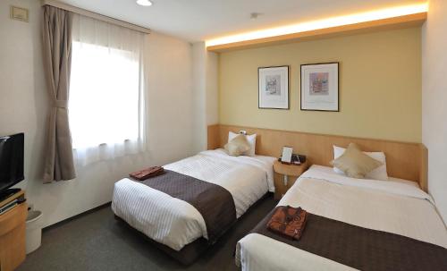 Ένα ή περισσότερα κρεβάτια σε δωμάτιο στο Hotel Annex Inn