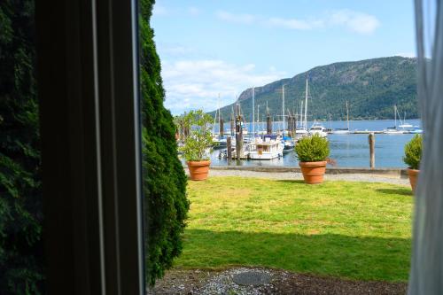 a window view of a marina with boats in the water at Oceanfront Suites at Cowichan Bay in Cowichan Bay