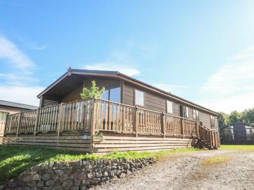 a house with a large deck on the side of it at Gressingham 22 in Carnforth