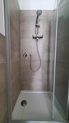 a shower with a shower head in a bathroom at B&B Lido Apartament 10A in Civitanova Marche