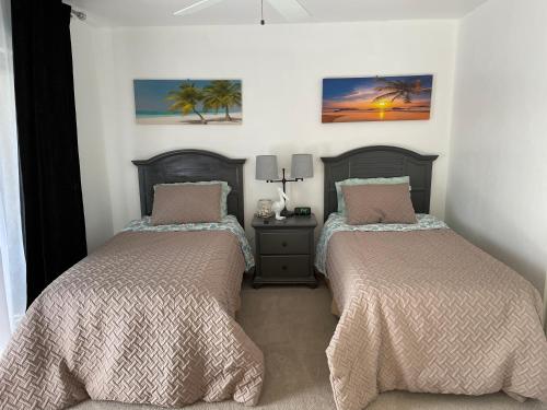 a bedroom with two beds and a night stand at Parkshore resort apartment in Naples