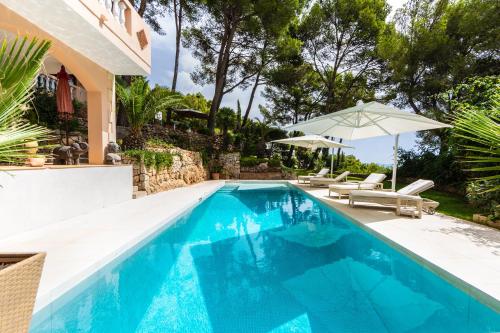 a swimming pool with a villa and a house at Villa Es Pont, bis 10Pers, BBQ in Son Vida