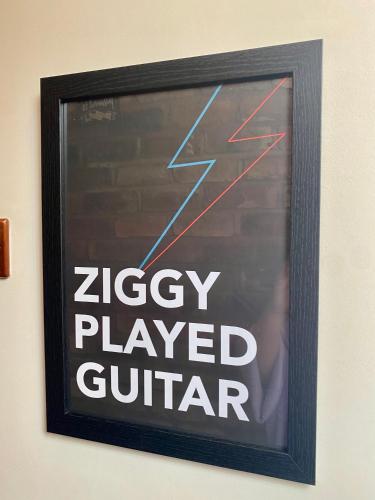 a sign that says ziggy played guitar on a wall at Private Loft Country Hideaway in Shifnal