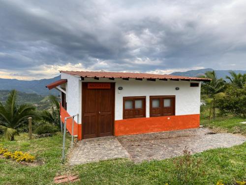 a small house on top of a hill at Cabañas y Flores in Jericó