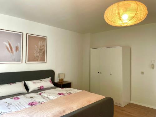 a bedroom with a bed and a white cabinet at Kelsbachhaus EG in Pförring