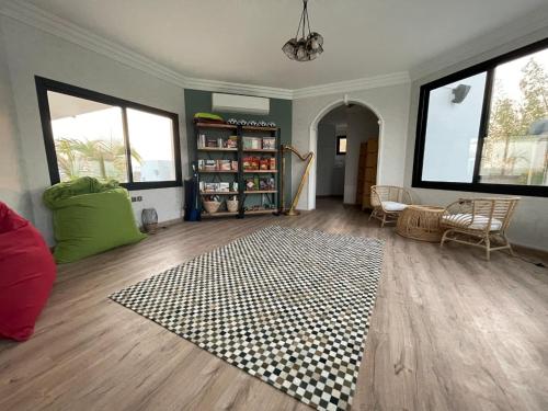 a living room with a rug on a wooden floor at Pura Eco Retreat, Jubail Island in Abu Dhabi