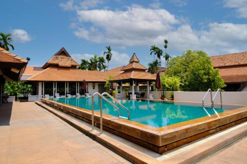 a swimming pool at a resort with a resort at Bodhi Serene, Chiang Mai - SHA Extra Plus in Chiang Mai