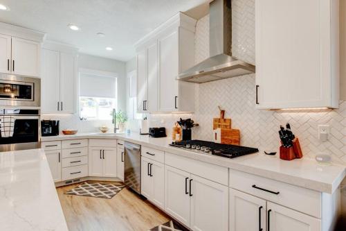 a kitchen with white cabinets and white counter tops at Midway to Heaven! BRAND NEW 5 bed 4.5 bath, HOTTUB in Midway