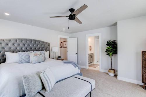 a bedroom with a large bed and a ceiling fan at Midway to Heaven! BRAND NEW 5 bed 4.5 bath, HOTTUB in Midway
