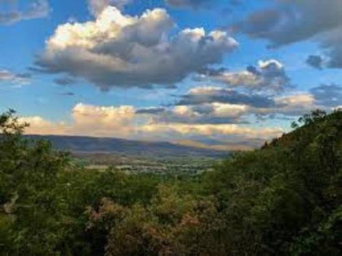 a view of a hill with trees and a cloudy sky at Midway to Heaven! BRAND NEW 5 bed 4.5 bath, HOTTUB in Midway