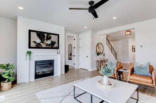 a living room with a table and a fireplace at Midway to Heaven! BRAND NEW 5 bed 4.5 bath, HOTTUB in Midway