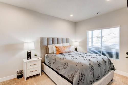 a bedroom with a large bed and a window at Midway to Heaven! BRAND NEW 5 bed 4.5 bath, HOTTUB in Midway