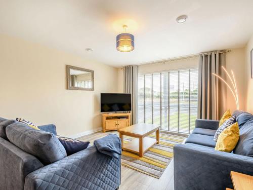 a living room with two couches and a tv at Oystercatcher in Drummore