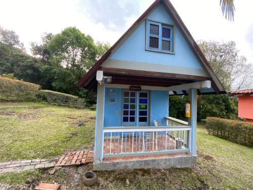 a small blue house with a gambrel roof at Cabañas y Flores in Jericó