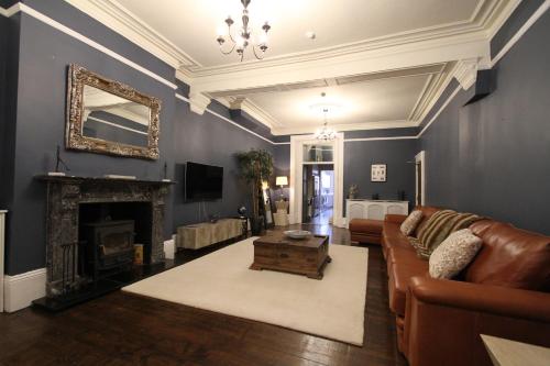 a living room with a couch and a fireplace at Amadeus Apartments in Douglas