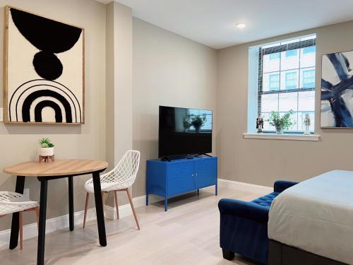 a bedroom with a bed and a table and a tv at Stay at Luna on Callowhill in Philadelphia