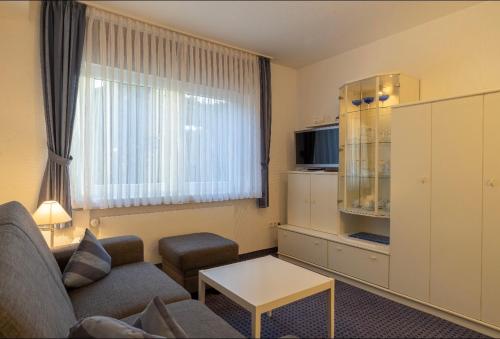a living room with a couch and a coffee table at Haus Kleemann in Norderney