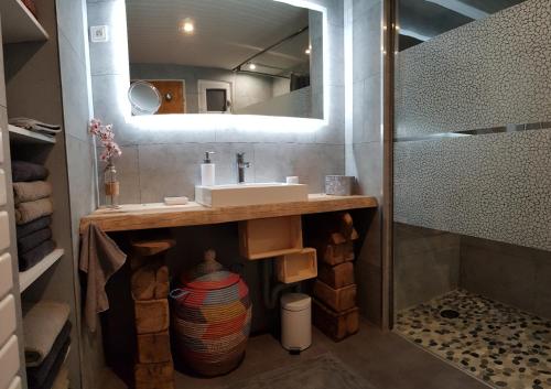a bathroom with a sink and a mirror at Gîte et SPA Chez Jules in Vellerot-lès-Vercel