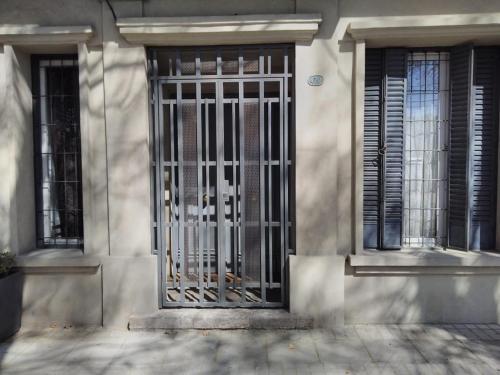 a metal gate on the side of a building at Loft Rufino in Mendoza