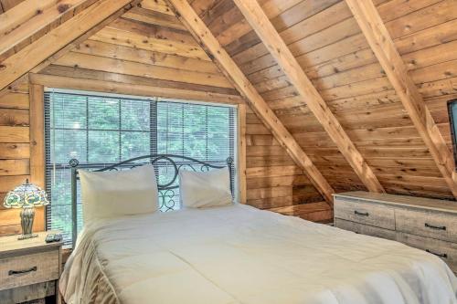 a bedroom with a bed in a room with wooden ceilings at Deer Haven Cabin 5 Mi to Dtwn Blue Ridge! in Blue Ridge