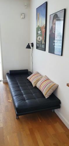 a black bed in a room with posters on the wall at Privat Villa in Skive