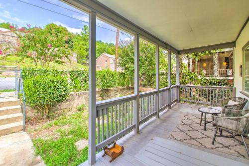 a porch with a chair and a table at Historic Home Near Bathhouse Row in Hot Springs! in Hot Springs