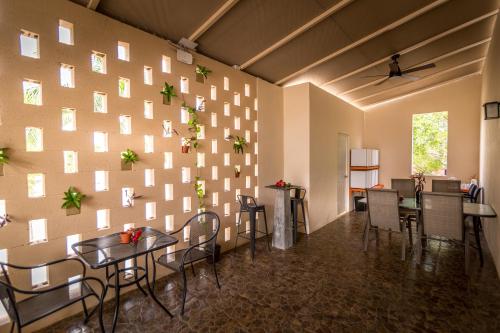 a room with a wall with tables and chairs at Azcapri Villa Boutique & Spa in Cancún