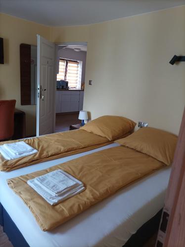 a bed with two blankets on top of it at Pokoje u Jana in Kazimierz Dolny