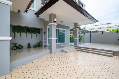 a home with a tile floor and white walls at April Pool Villa Airport in Chiang Mai