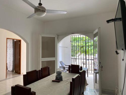 聖瑪爾塔的住宿－Apartamento con aire acondicionado y parqueadero por dias en Santa Marta，一间带桌子和吊扇的用餐室