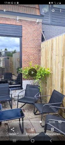 a group of chairs sitting on a patio at Huis nummer 7 met sauna en 3 slaapkamers in Leeuwarden