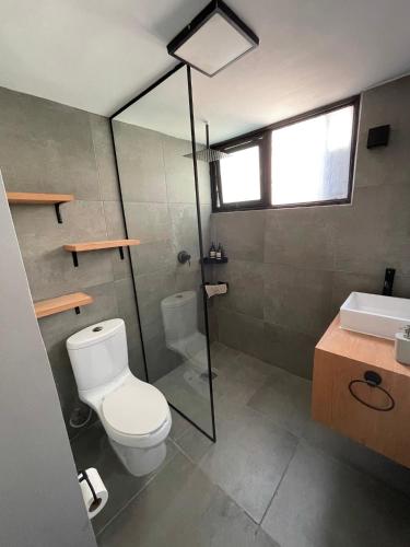 a bathroom with a toilet and a shower and a sink at CHIC Full Condo @ - Heart of Roma, downtown CDMX in Mexico City
