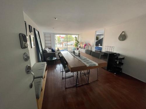 a dining room and living room with a table and chairs at CHIC Full Condo @ - Heart of Roma, downtown CDMX in Mexico City