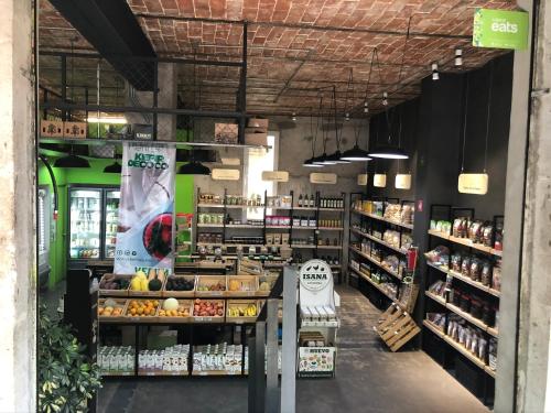 a grocery store aisle with fruits and vegetables on shelves at CHIC Full Condo @ - Heart of Roma, downtown CDMX in Mexico City