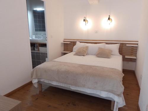a bedroom with a large bed with two pillows at Studio mezzanine hyper centre, au pied du castillet in Perpignan
