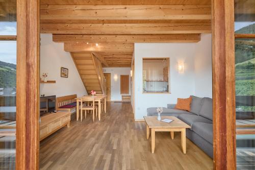 a living room with a couch and a table at Kircherhof in Bressanone
