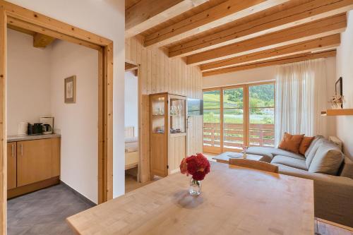a living room with a couch and a table at Kircherhof in Bressanone
