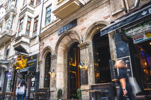 a building on a street with people walking in front of it at West Pera Hotel in Istanbul