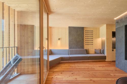 a living room with a blue couch in a room at Kircherhof in Bressanone