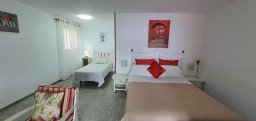 a bedroom with two beds and a couch in it at APARTAMENTO LOS CACTUS in Echedo
