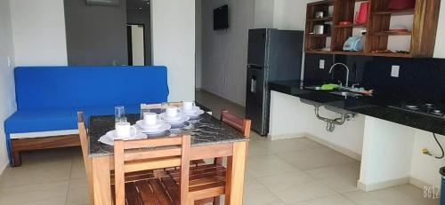 a kitchen with a table with chairs and a blue couch at MALAKI in Los Ayala
