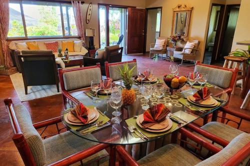 a dining room with a table with wine glasses at Unique Lava House by steaming crater in Pahoa