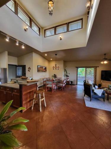 a large room with a kitchen and a living room at Unique Lava House by steaming crater in Pahoa