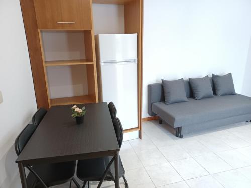 a living room with a table and a couch at Enjoy Oporto Campanha 3 in Porto
