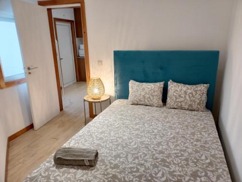 a bedroom with a large bed with a blue headboard at Enjoy Oporto Campanha 3 in Porto