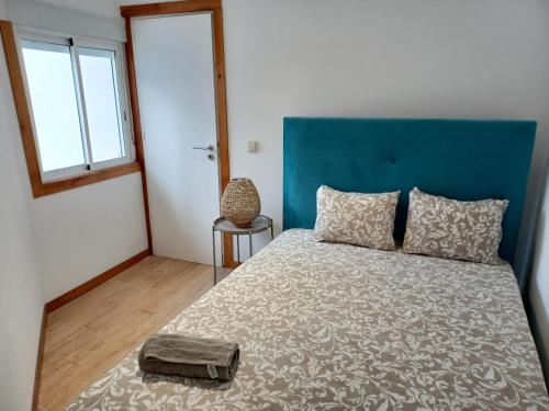 a bedroom with a large bed with a blue headboard at Enjoy Oporto Campanha 3 in Porto